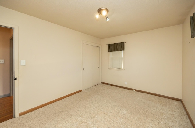 carpeted spare room with baseboards