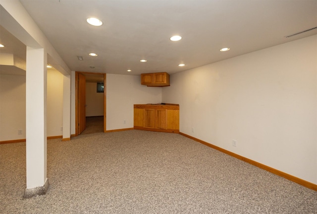 finished basement with light carpet, recessed lighting, visible vents, and baseboards