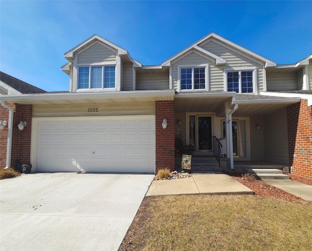 view of front of house with concrete driveway and brick siding