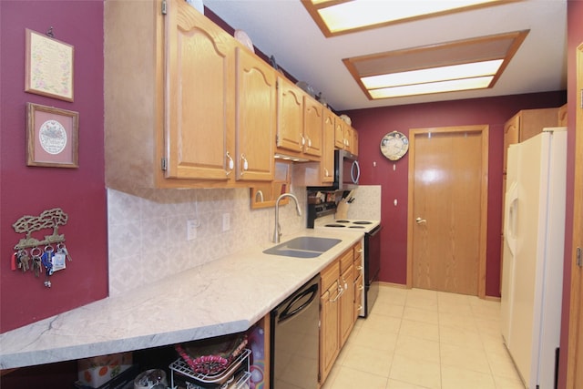 kitchen featuring a sink, stainless steel microwave, electric range oven, freestanding refrigerator, and dishwashing machine