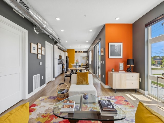 450 SW 7th St Unit 210, Des Moines, IA 50309 - dining space featuring recessed lighting, light wood-style flooring, baseboards, and a chandelier