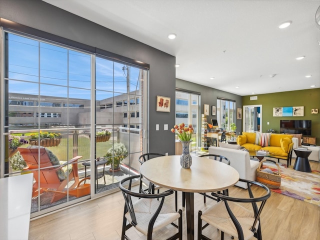 dining space with recessed lighting and wood finished floors