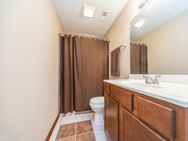 bathroom featuring toilet, visible vents, baseboards, vanity, and tile patterned floors