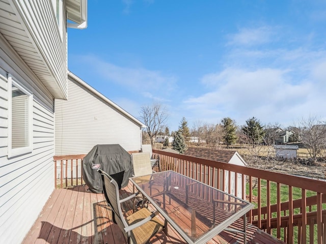 deck featuring grilling area and outdoor dining area