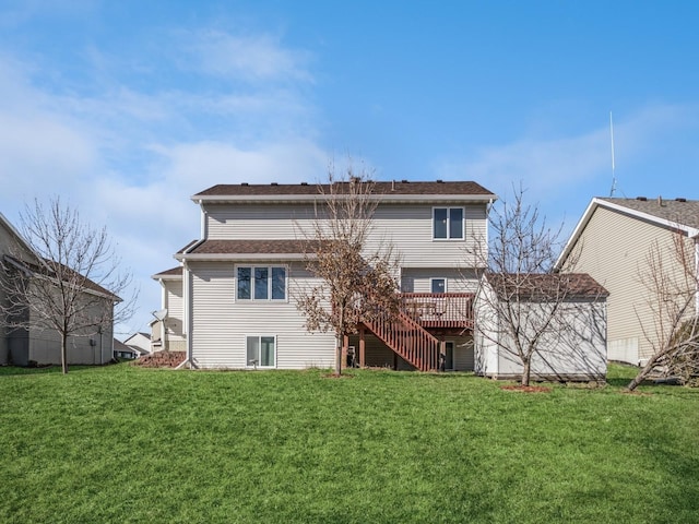 rear view of house featuring a deck, a yard, and stairway