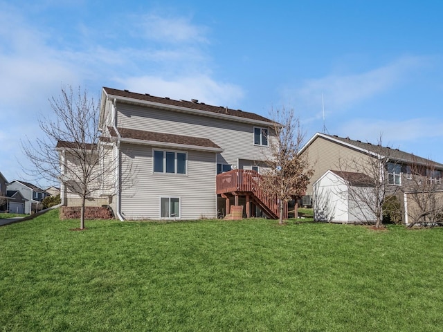 rear view of property with a yard, a wooden deck, and stairs