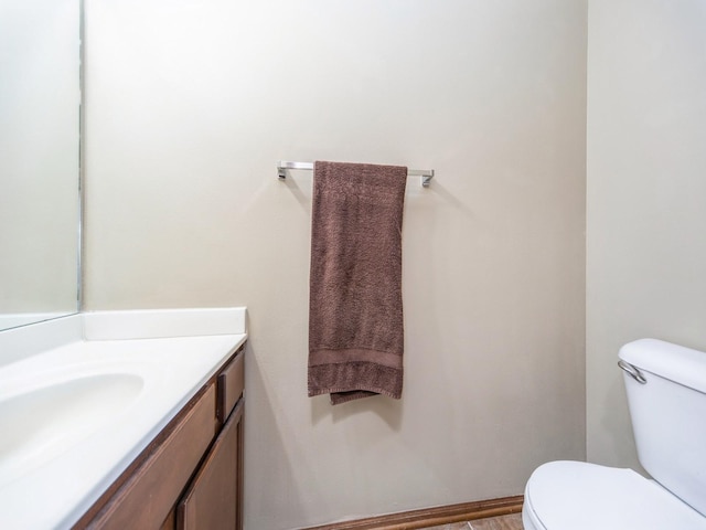 bathroom featuring toilet and vanity