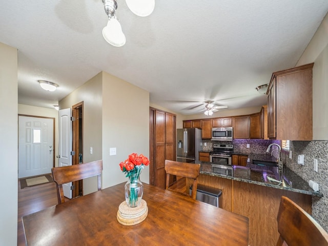 dining area featuring a ceiling fan and wood finished floors