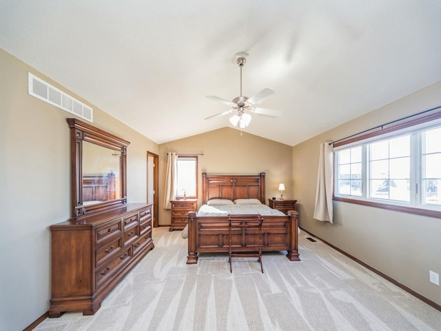 bedroom featuring visible vents, vaulted ceiling, light carpet, and baseboards