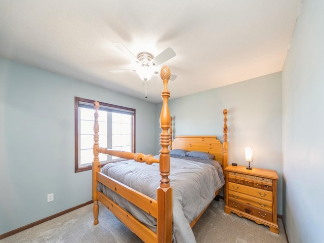 carpeted bedroom with a ceiling fan and baseboards