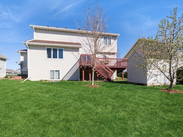 604 NW 8th St, Grimes, IA 50111 - rear view of house with a yard, an outbuilding, a wooden deck, and stairs