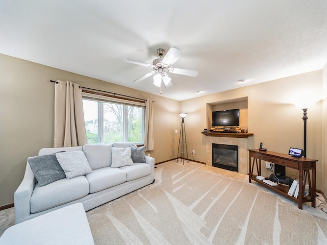 604 NW 8th St, Grimes, IA 50111 - living area with baseboards, carpet flooring, ceiling fan, and a tile fireplace