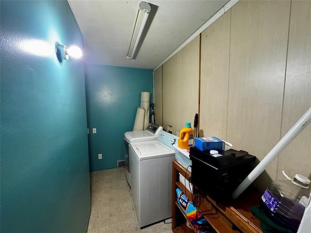 laundry area with laundry area, light floors, and washer and dryer