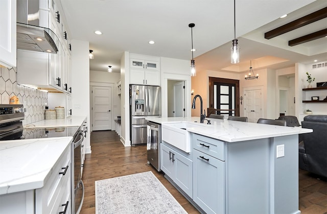 kitchen featuring stainless steel appliances, dark wood-type flooring, visible vents, backsplash, and wall chimney exhaust hood