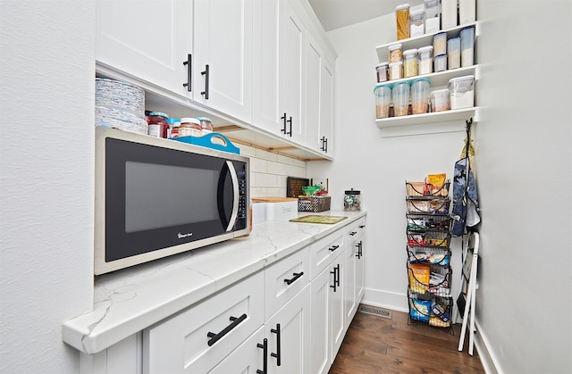 5021 148th Cir, Urbandale, IA 50323 - kitchen featuring backsplash, dark wood-style flooring, white cabinets, light stone countertops, and open shelves