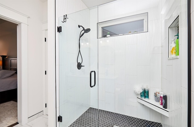 ensuite bathroom featuring a stall shower and connected bathroom