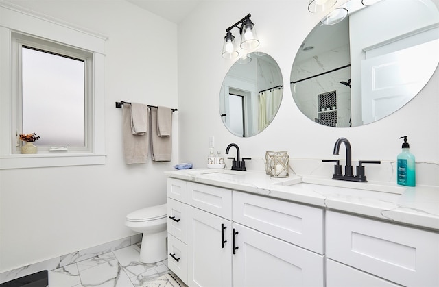 bathroom with marble finish floor, a shower with shower curtain, a sink, and toilet