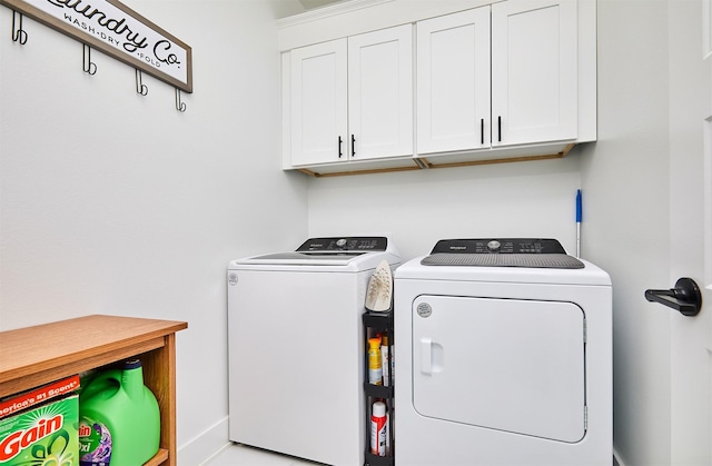 washroom featuring cabinet space and washing machine and clothes dryer