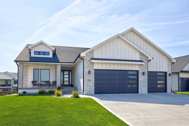 5021 148th Cir, Urbandale, IA 50323 - modern farmhouse style home with a garage, a front lawn, concrete driveway, board and batten siding, and covered porch