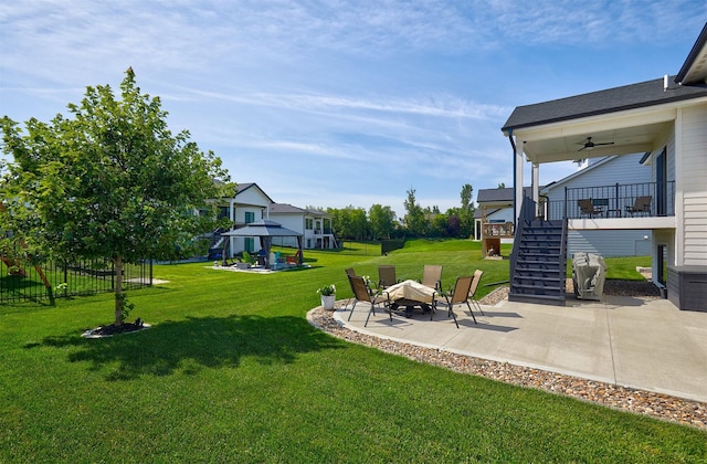 5021 148th Cir, Urbandale, IA 50323 - view of yard featuring a gazebo, stairway, a patio, and a ceiling fan