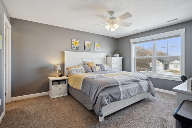 bedroom featuring visible vents, baseboards, a ceiling fan, a textured ceiling, and carpet floors