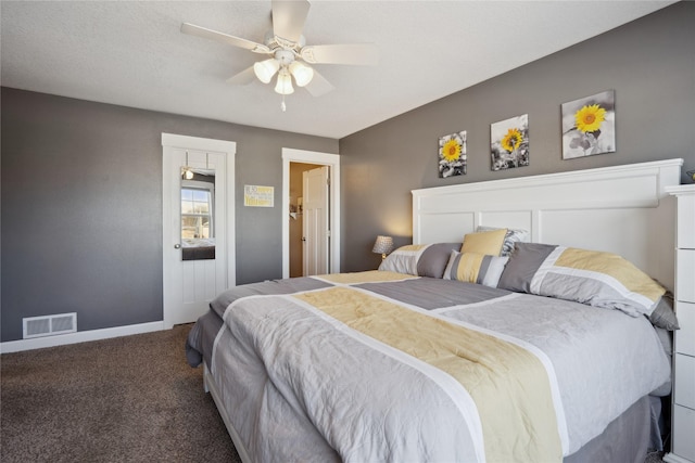 carpeted bedroom with baseboards, visible vents, and a ceiling fan