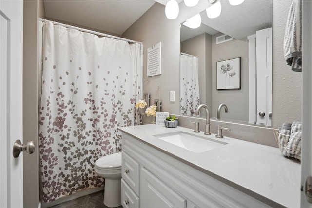 bathroom featuring visible vents, vanity, and toilet