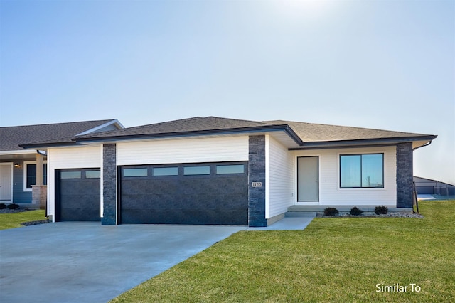 prairie-style home featuring a front lawn, concrete driveway, roof with shingles, and an attached garage