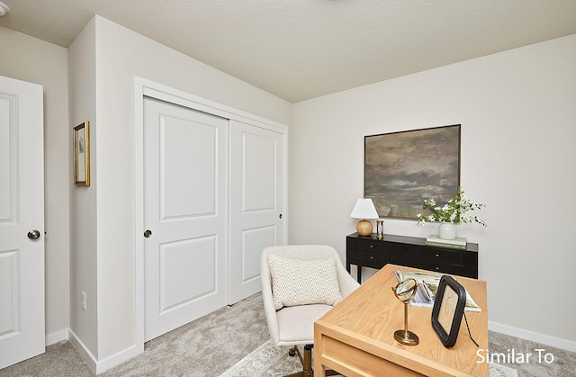 carpeted office space with baseboards