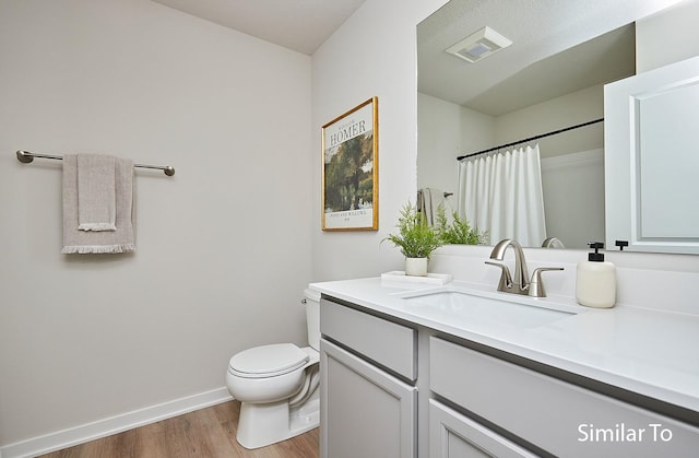 full bathroom with wood finished floors, toilet, vanity, baseboards, and a shower with shower curtain