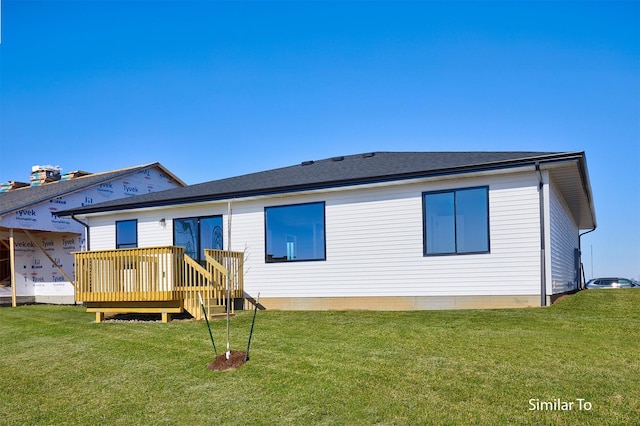 back of house with a yard and a deck