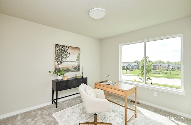 carpeted office space with a residential view, visible vents, and baseboards