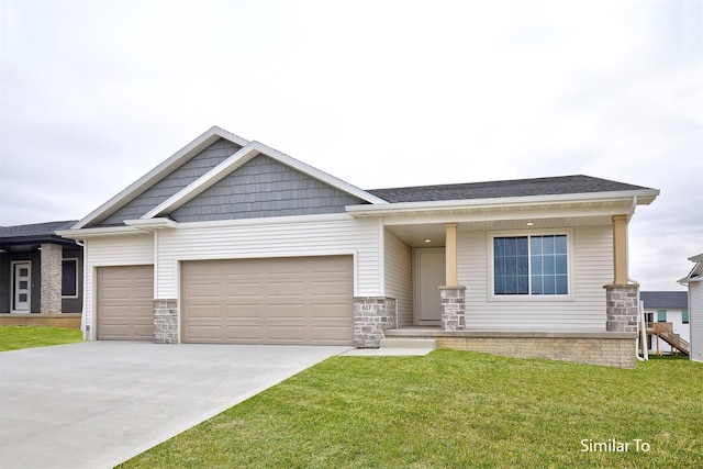 craftsman-style house featuring a garage, a front yard, stone siding, and driveway