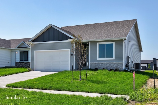 craftsman inspired home with concrete driveway, an attached garage, cooling unit, a front lawn, and board and batten siding