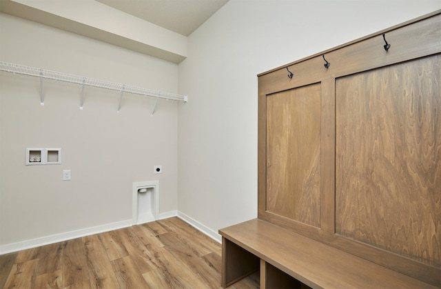 laundry room featuring light wood-style flooring, baseboards, washer hookup, electric dryer hookup, and laundry area