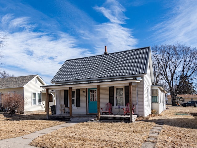 view of front of home with a porch and metal roof