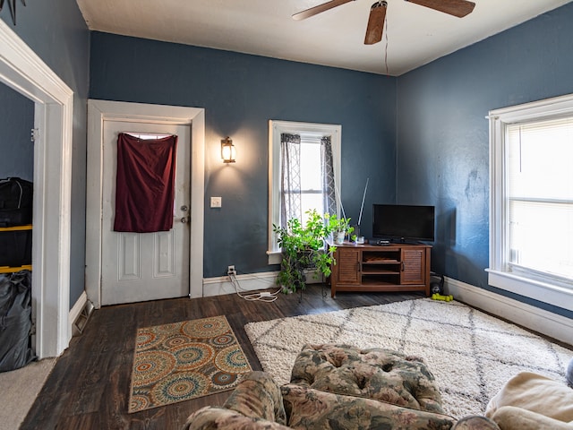 entryway featuring wood finished floors, a ceiling fan, and baseboards