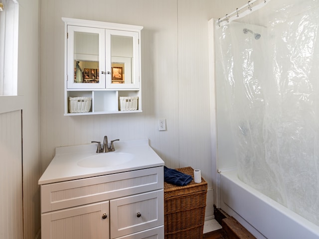 bathroom with shower / bath combo with shower curtain and vanity