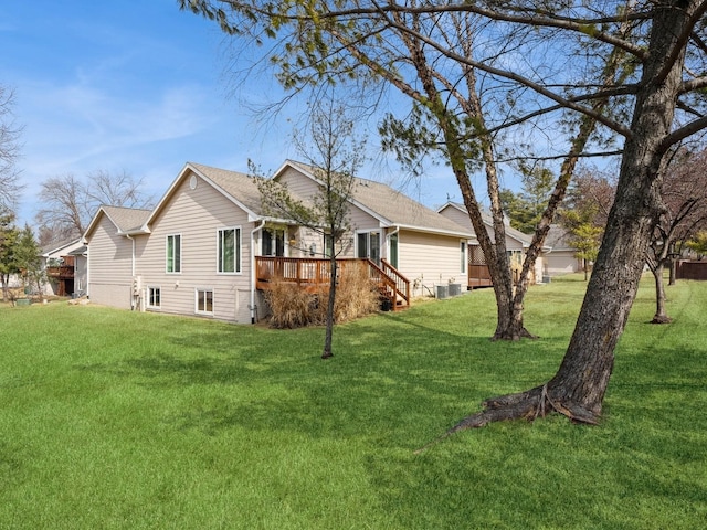 view of property exterior with central air condition unit, a wooden deck, and a yard