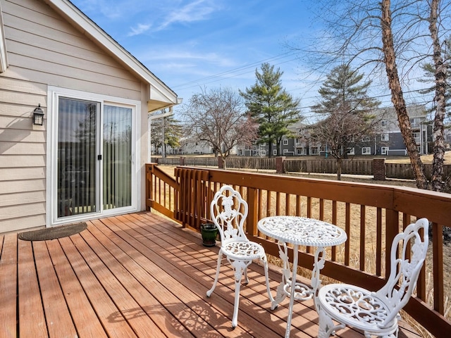 wooden terrace featuring fence