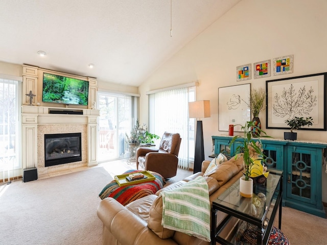 living room featuring high vaulted ceiling, a large fireplace, and light colored carpet