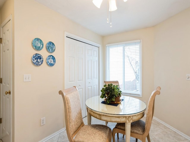 dining room featuring baseboards and light tile patterned floors