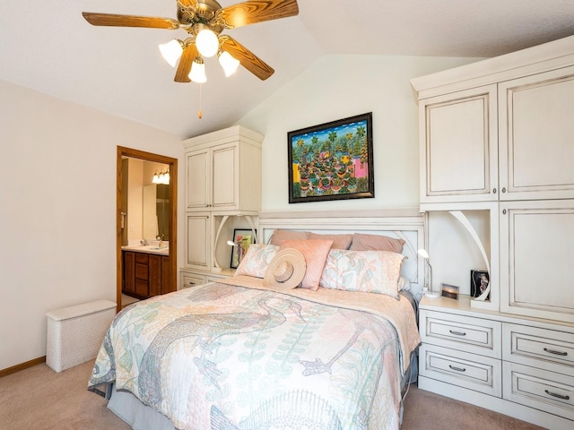 bedroom featuring lofted ceiling, ensuite bath, ceiling fan, and light colored carpet