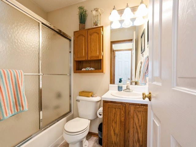 full bathroom featuring toilet, shower / bath combination with glass door, and vanity