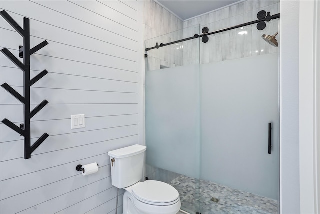 bathroom featuring toilet and a stall shower