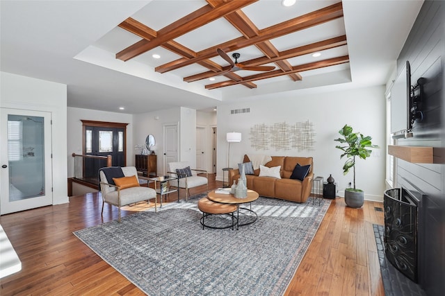 living area with hardwood / wood-style flooring, visible vents, coffered ceiling, and beamed ceiling