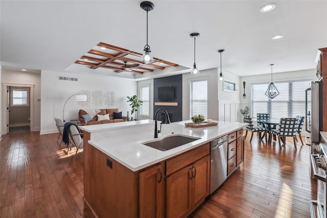 kitchen with stainless steel appliances, coffered ceiling, a sink, visible vents, and light countertops