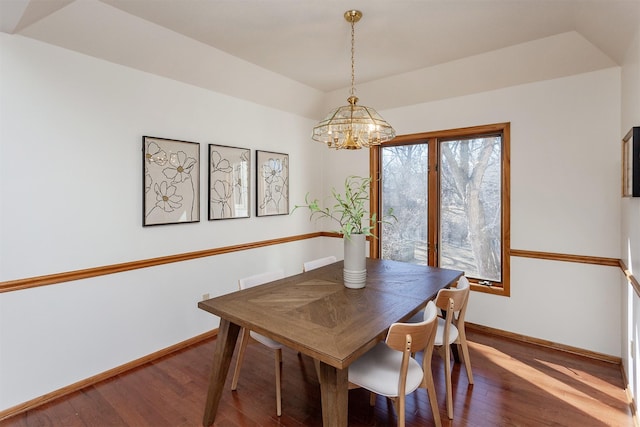 dining room with baseboards, wood finished floors, and a chandelier