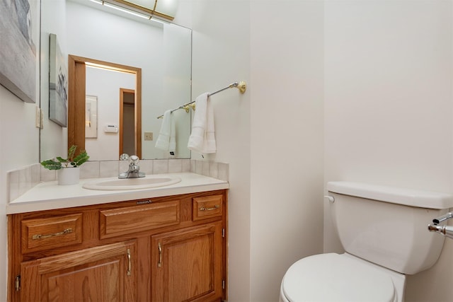 half bathroom featuring toilet and vanity