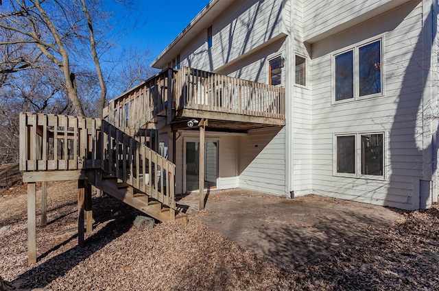 rear view of house featuring a patio, stairway, and a wooden deck